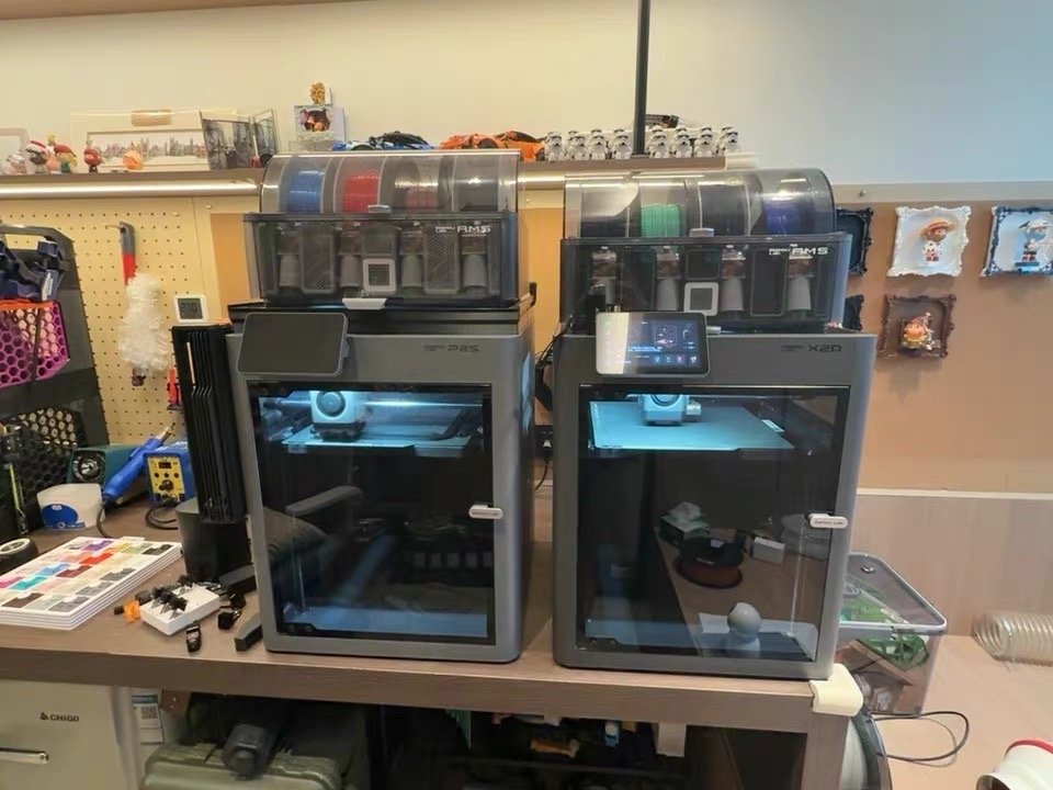 Bambu Lab P2S and X2D side by side comparison in a real maker workspace
