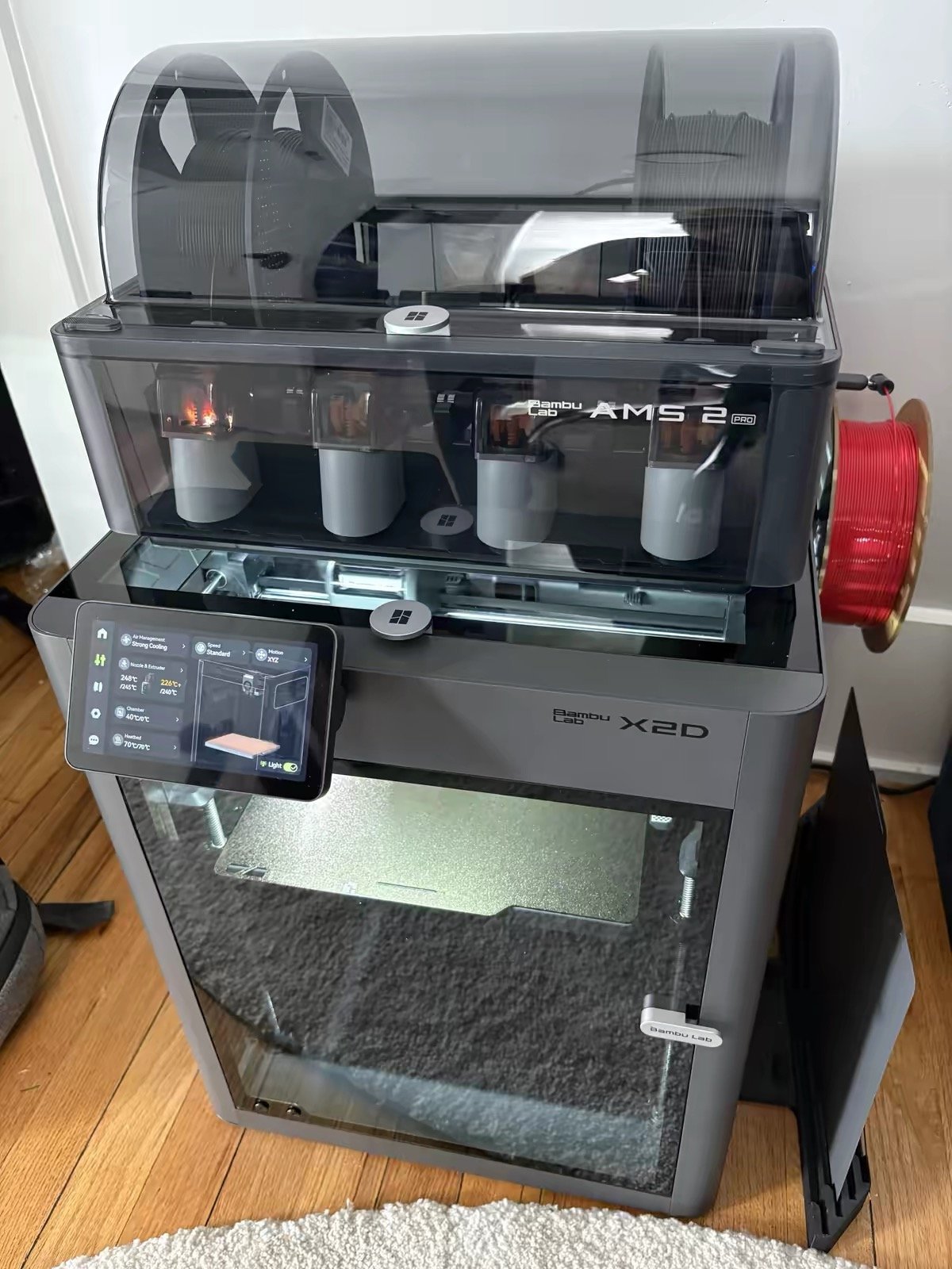 Bambu Lab X2D with AMS 2 Pro full setup front view in real home environment