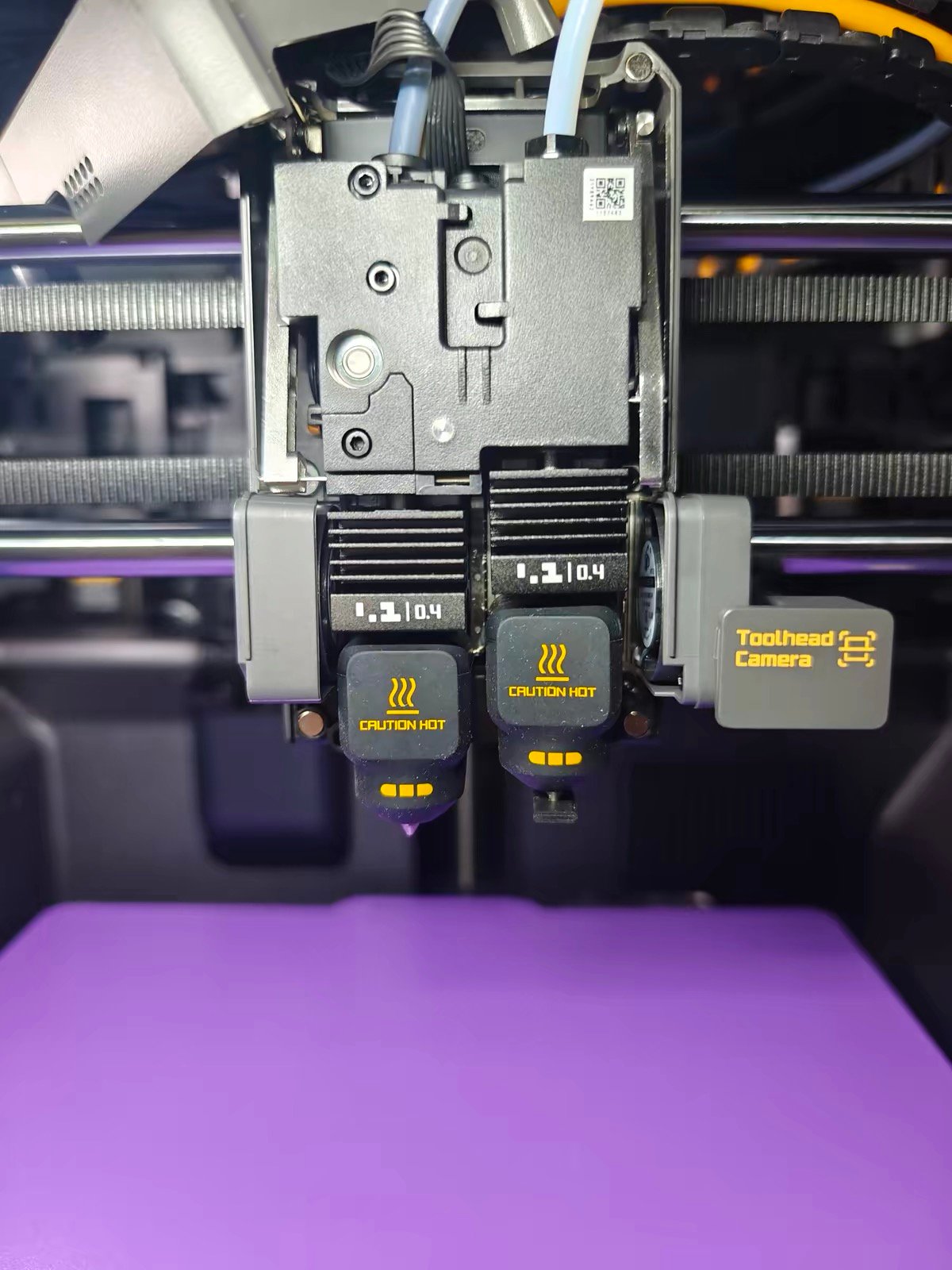 Bambu Lab X2D vs Snapmaker U1 (2026): Dual Nozzle vs Tool Changer — Which Should You Buy? 4 Bambu Lab X2D dual nozzle with Toolhead Camera close-up on purple print bed