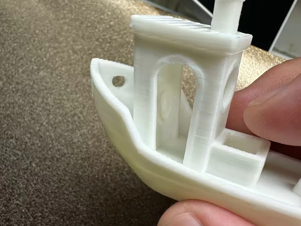 Bambu Lab A2L First Setup Guide: Unboxing to First Print (Without the Day-One Mistakes) 7 White 3DBenchy test boat printed on the Bambu Lab A2L, held in hand