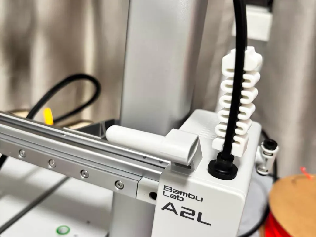 Bambu Lab A2L vs A1 (2026): Bigger, Smarter, and One Catch — Which Should You Buy? 6 Close-up of the Bambu Lab A2L gantry showing the A2L badge, cable strain relief, and linear rail