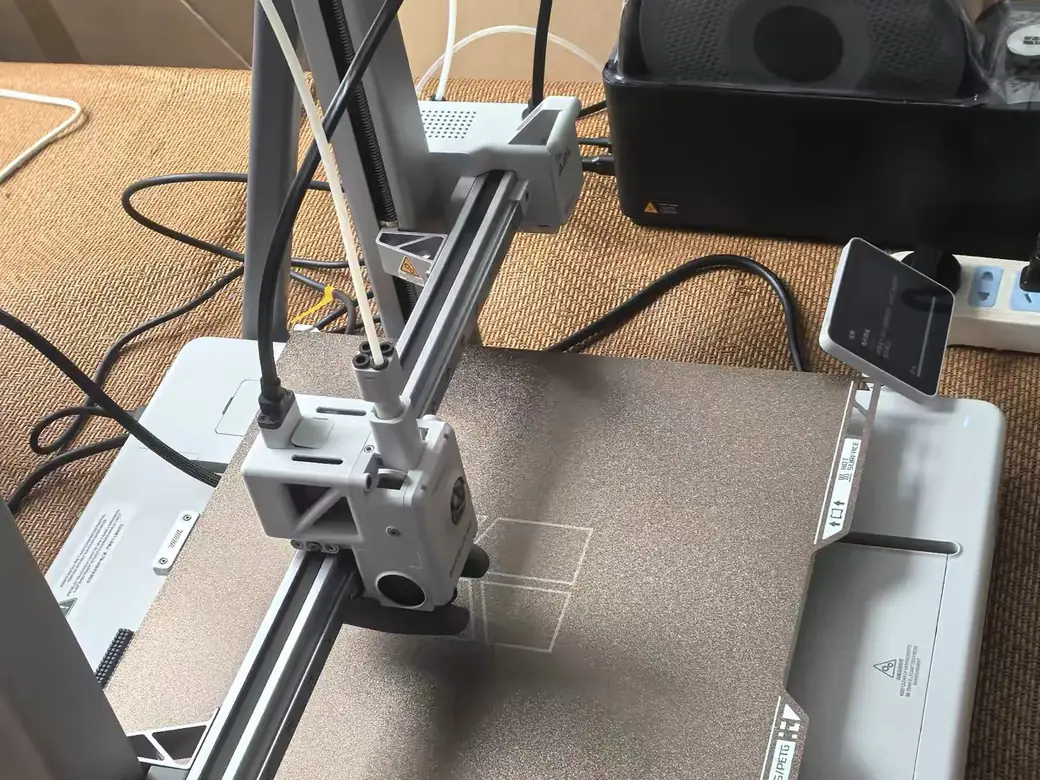 Best Bambu Lab 3D Printer for 2026: How to Pick the One That's Right for You 7 Bambu Lab A2L on a desk beside a filament drying box, side view