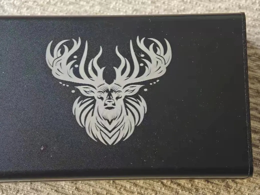 The Best Laser Engravers in 2026 (Tested, Honest, By Type) 6 Detailed stag design engraved on a black anodized metal card