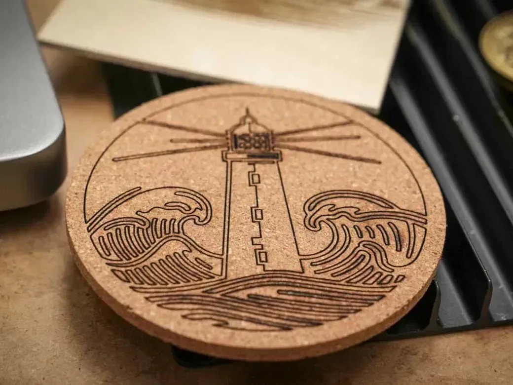 The Best Laser Engravers in 2026 (Tested, Honest, By Type) 7 Lighthouse design laser-engraved on a round cork coaster