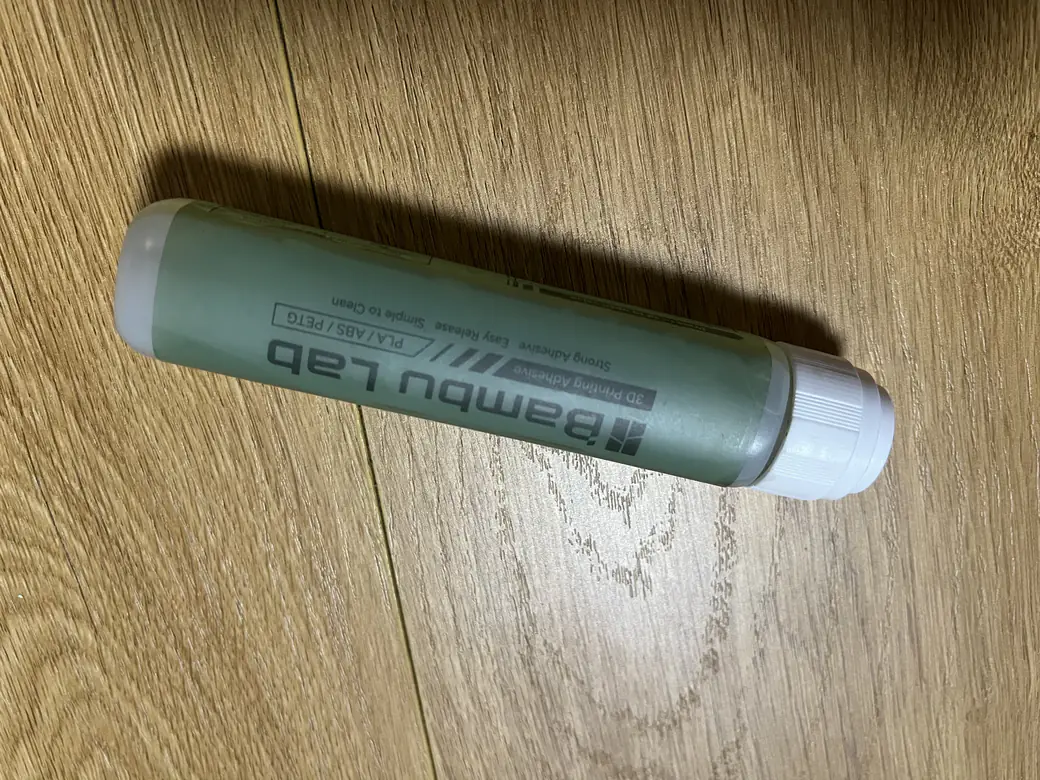 Bambu Lab 3D Printing Adhesive glue stick for PLA, ABS and PETG on a wood desk