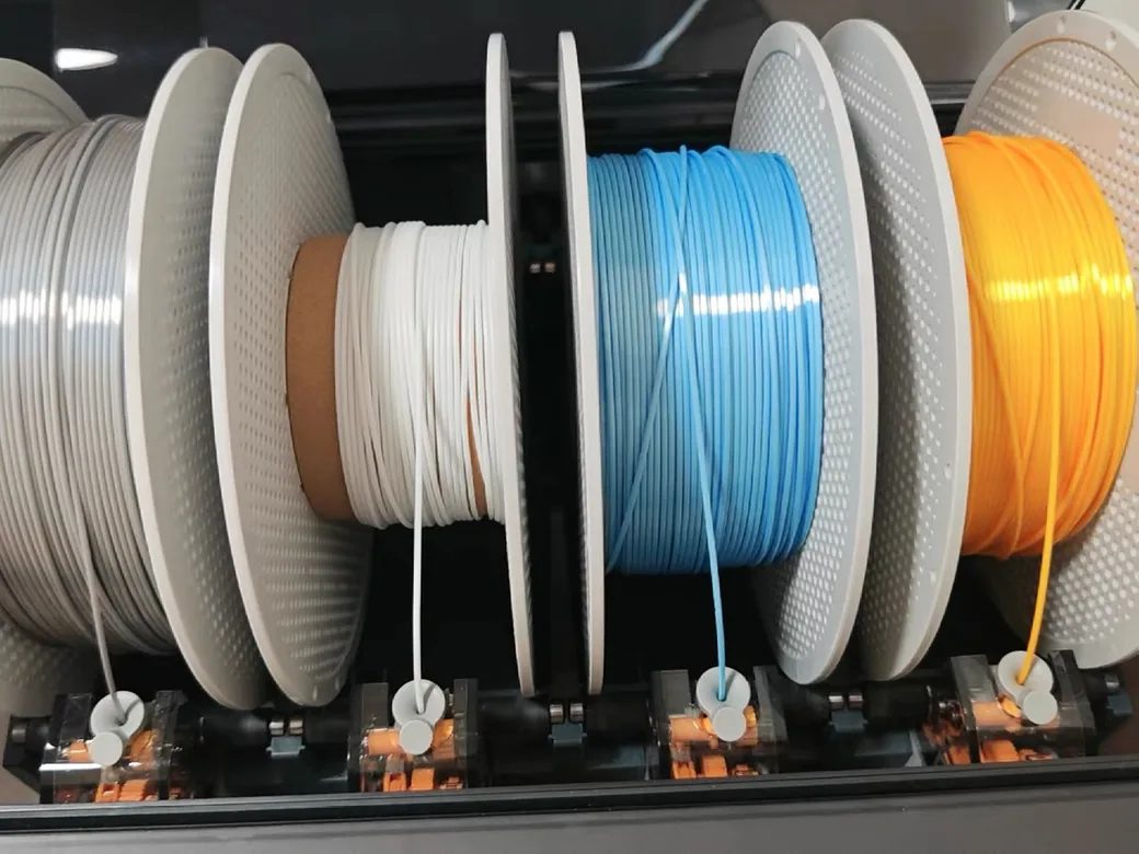 Multiple filament spools stored on a rack for dry storage