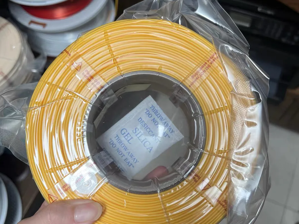 How to Dry Filament Without a Dryer 7 A filament spool sealed in a plastic bag with a silica gel desiccant packet