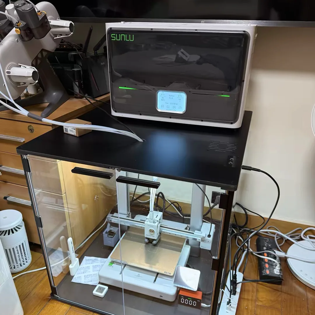 SUNLU S4 Filament Dryer Review: A 4-Spool Workhorse With One Rule You Can't Ignore 5 SUNLU S4 filament dryer running on top of an enclosure while a Bambu Lab A1 prints inside