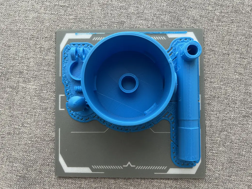 ugee Funbox 3D Printer Review: I Gave It to a 6-Year-Old for a Week 18 Large blue printed air launcher parts resting on the build plate