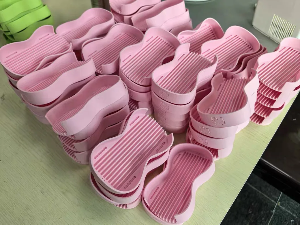 Food Safe 3D Printer Filament: What's Actually Certified, and What Still Isn't 2 Batch of pink 3D printed containers on a bench with visible layer lines along the walls