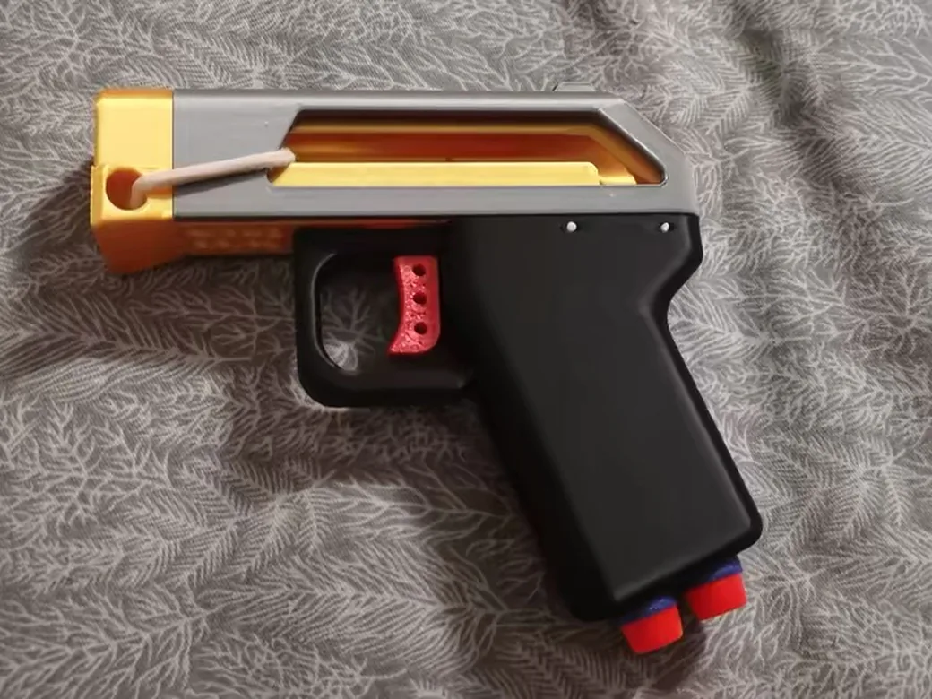 How to Split 3D Model Into Parts for Printing (Without Ruining the Fit) 7 Toy blaster assembled from separately printed grey, orange, black and red parts