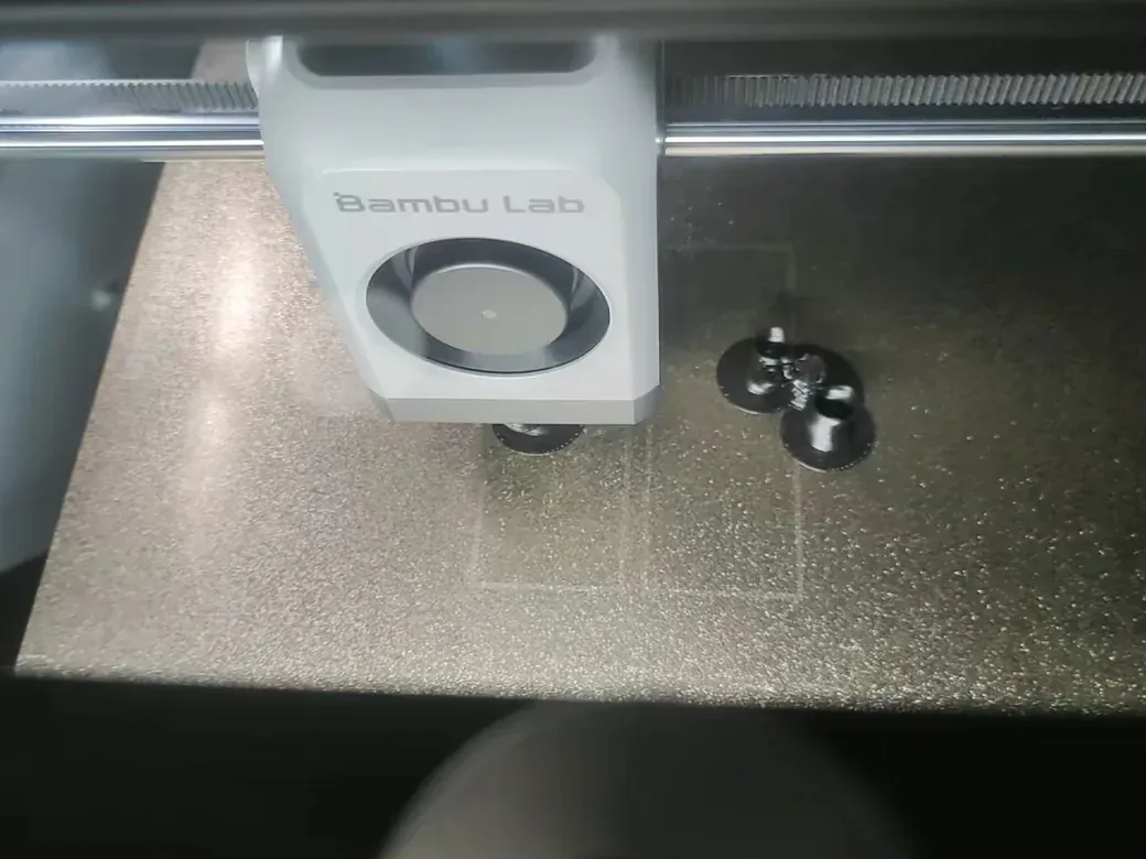 3D Printer Settings: A Beginner's Guide to Better Prints 3 3D printer print head laying the first layer on a textured PEI build plate