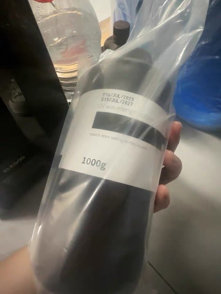 The Difference Between ABS-Like and Standard Resin (What the Tests Actually Show) 3 An Elegoo 1000g resin bottle still in its shipping bag, held in one hand.