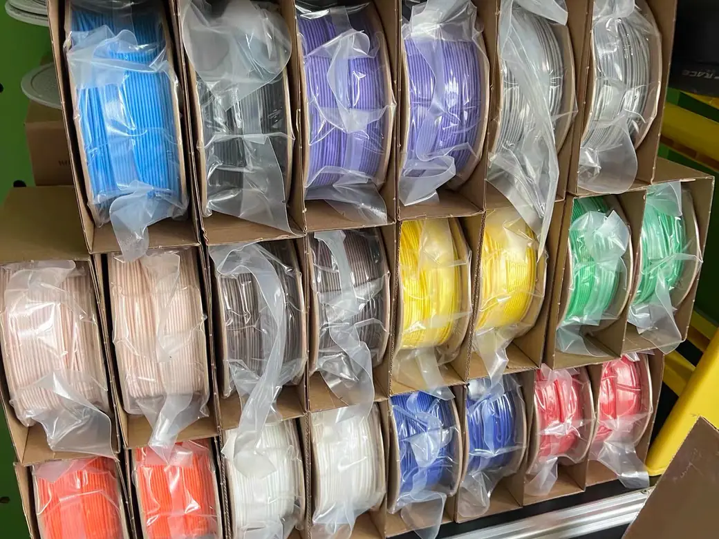 Filament Storage Ideas: 6 Setups Ranked by Cost, Capacity, and What They Don't Fix 3 Bagged filament spools stood on edge in cardboard dividers, every color visible at a glance