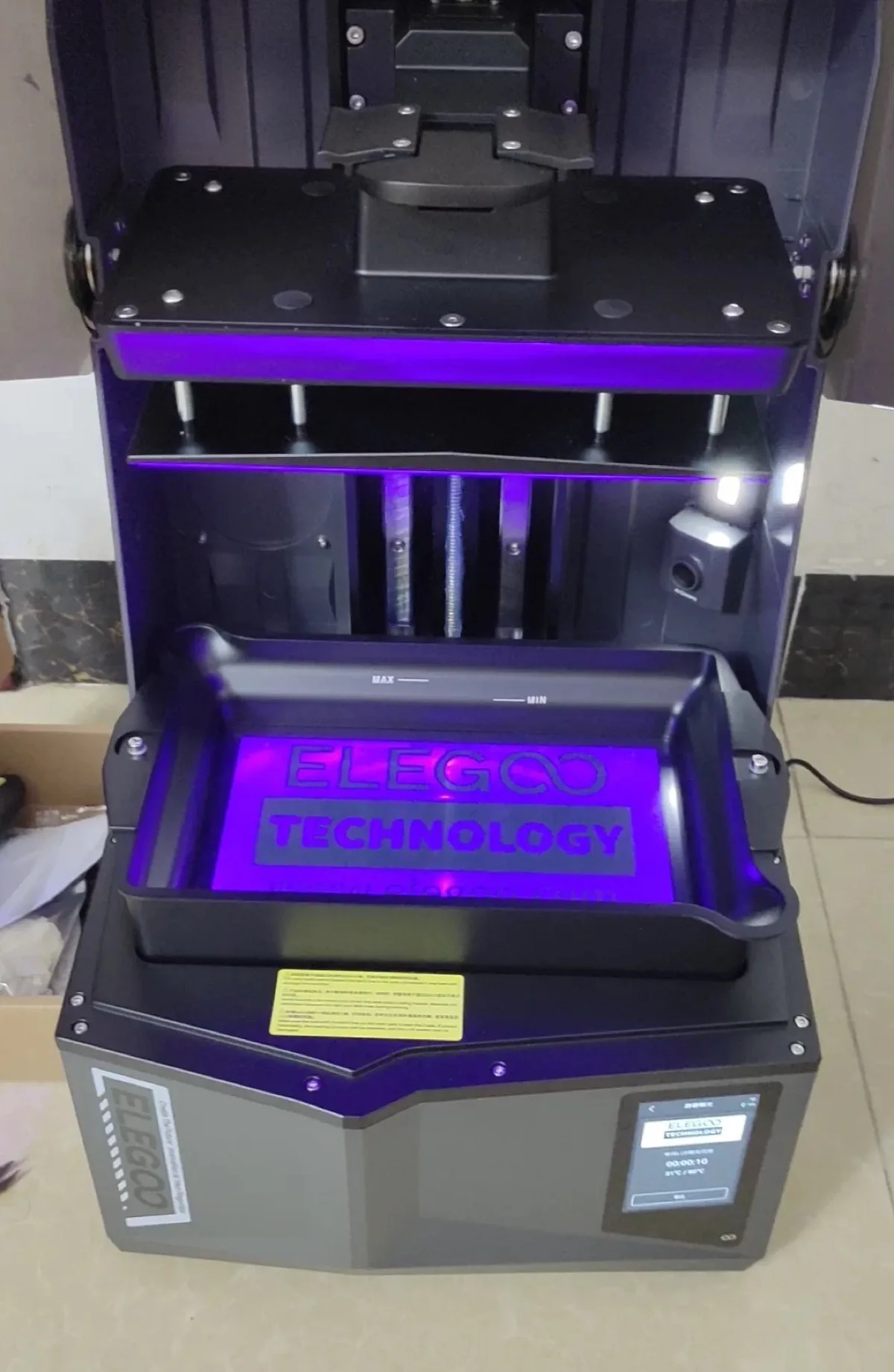 How Does a Resin Printer Work? (And What's Actually Hard About It) 3 Inside a resin 3D printer showing the resin vat, build plate and UV light with the lid open