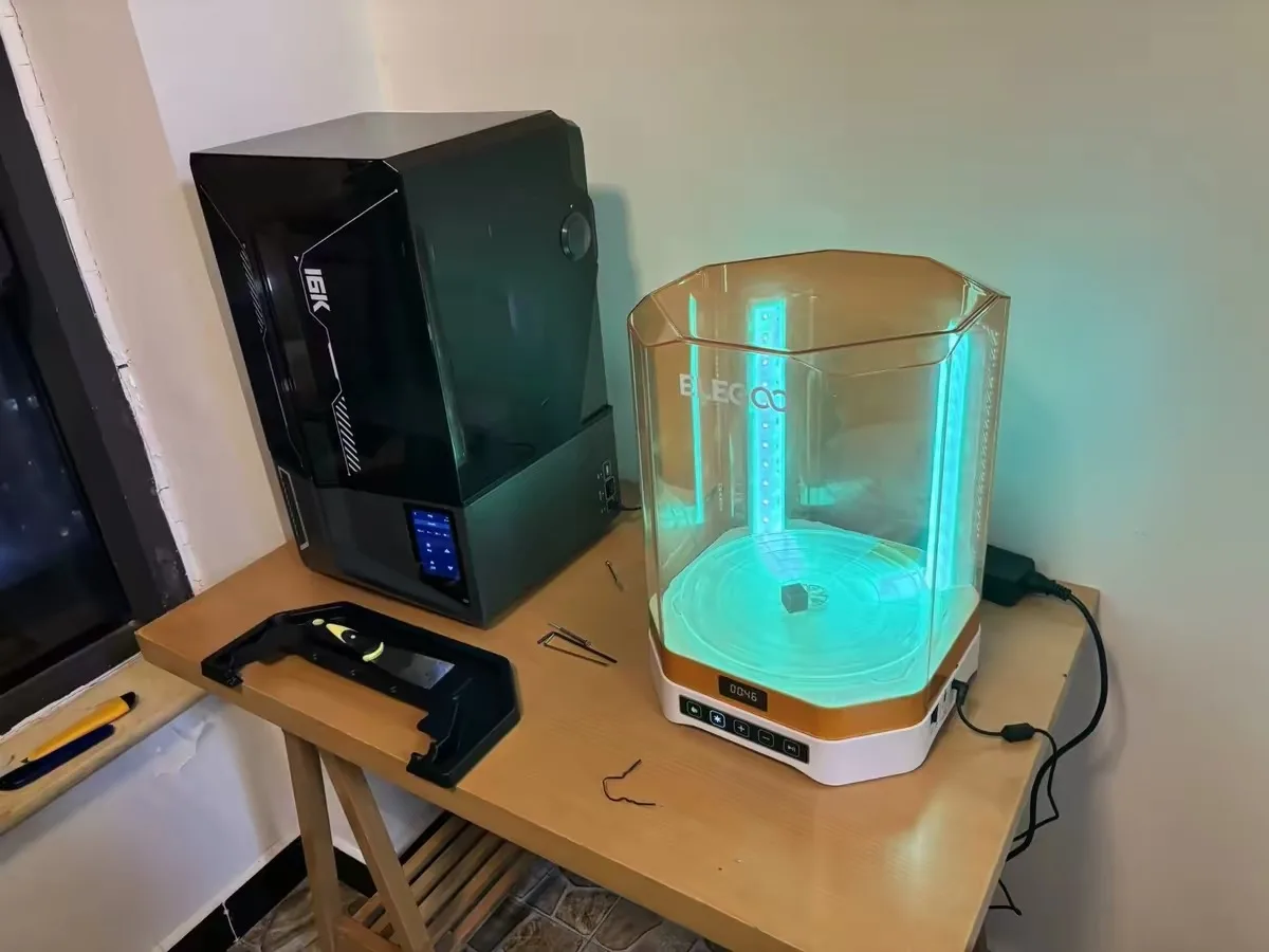 How Does a Resin Printer Work? (And What's Actually Hard About It) 4 A resin print curing under blue UV light inside a wash and cure station next to the printer
