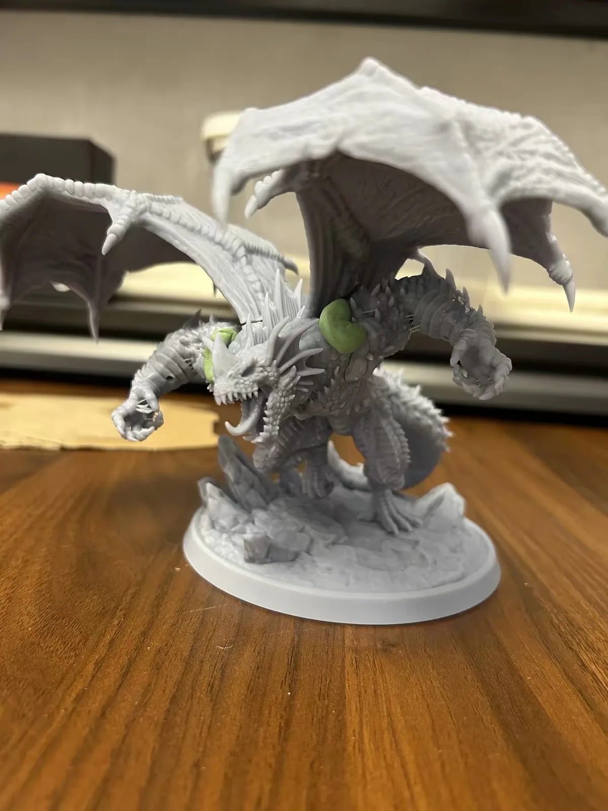 How Does a Resin Printer Work? (And What's Actually Hard About It) 14 A grey resin printed dragon miniature showing fine scale and wing membrane detail