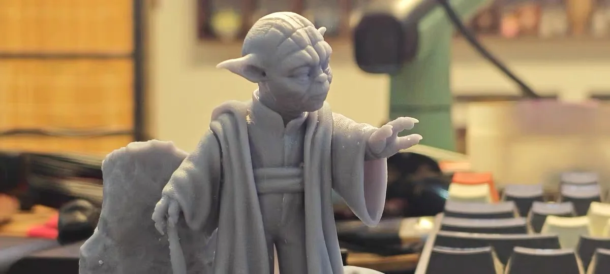 How Does a Resin Printer Work? (And What's Actually Hard About It) 2 Close up of a resin printed Yoda miniature showing smooth robe folds and facial detail