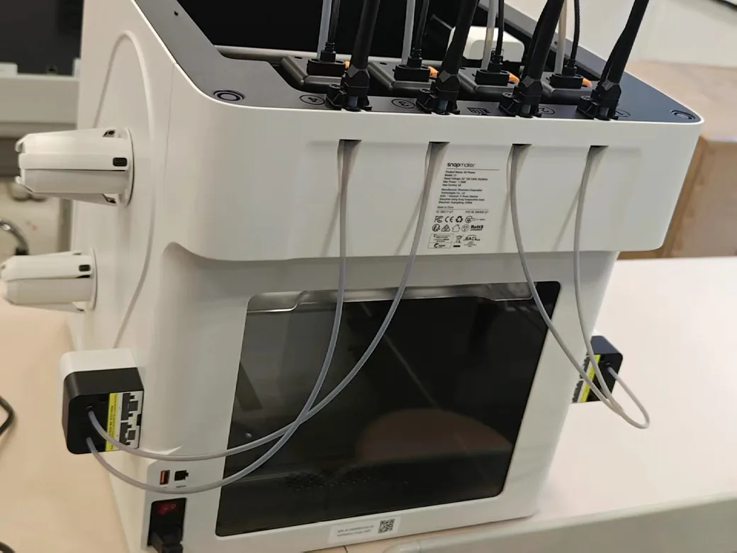 Rear of the Snapmaker U1 showing numbered feed ports, side spool holders, rear USB port and power switch