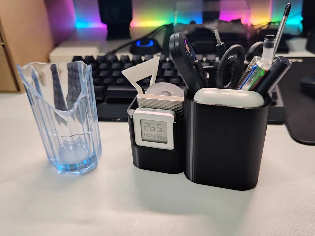 Is PLA Waterproof? What Actually Happens When Your Print Gets Wet 2 Translucent blue vase-mode PLA print beside two printed desk organizers, single spiral wall visible