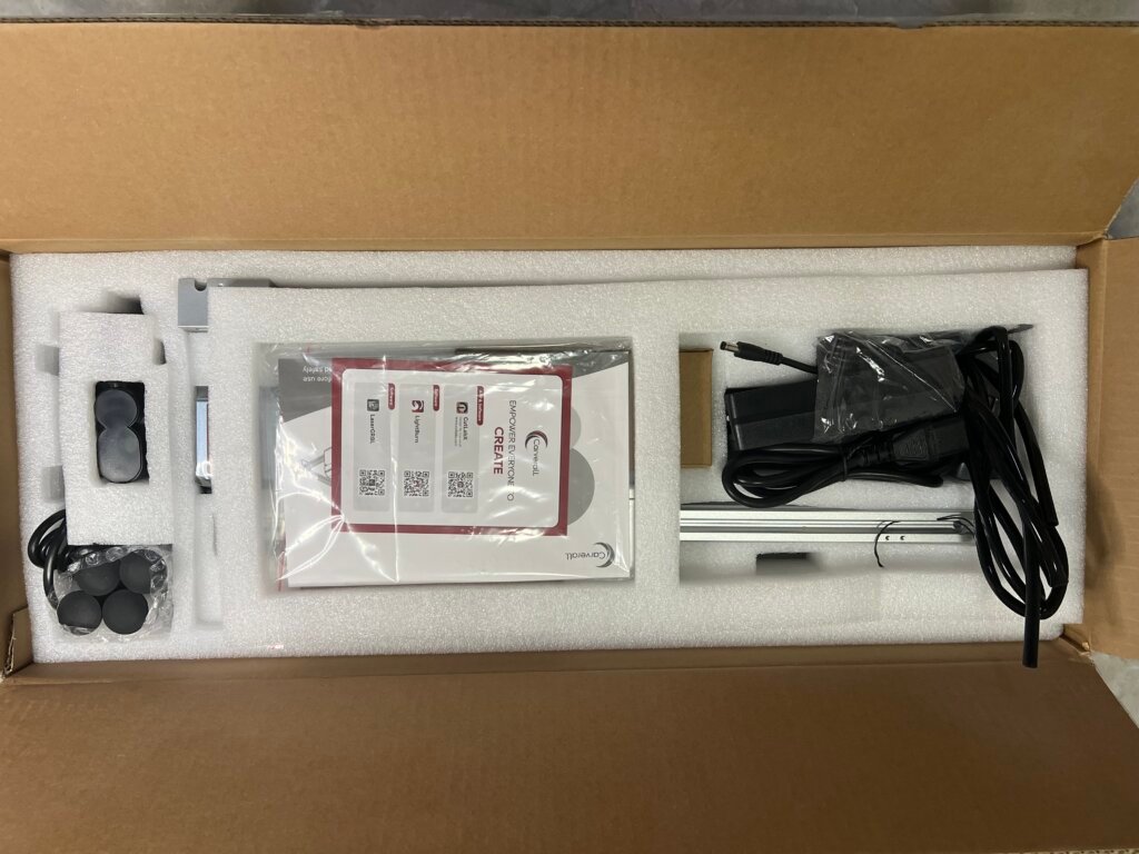 Carverall X1Pro Unboxing: Specs, Price, and What's in the Box (2026) 5 Carverall X1Pro foam packaging tray showing the printed manual, power adapter, and cabling