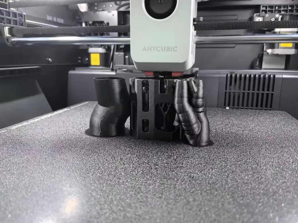 The Best Anycubic Kobra S1 Max Upgrades Worth Buying (2026) 4 Anycubic Kobra S1 Max print head sitting on the textured PEI plate after finishing a print
