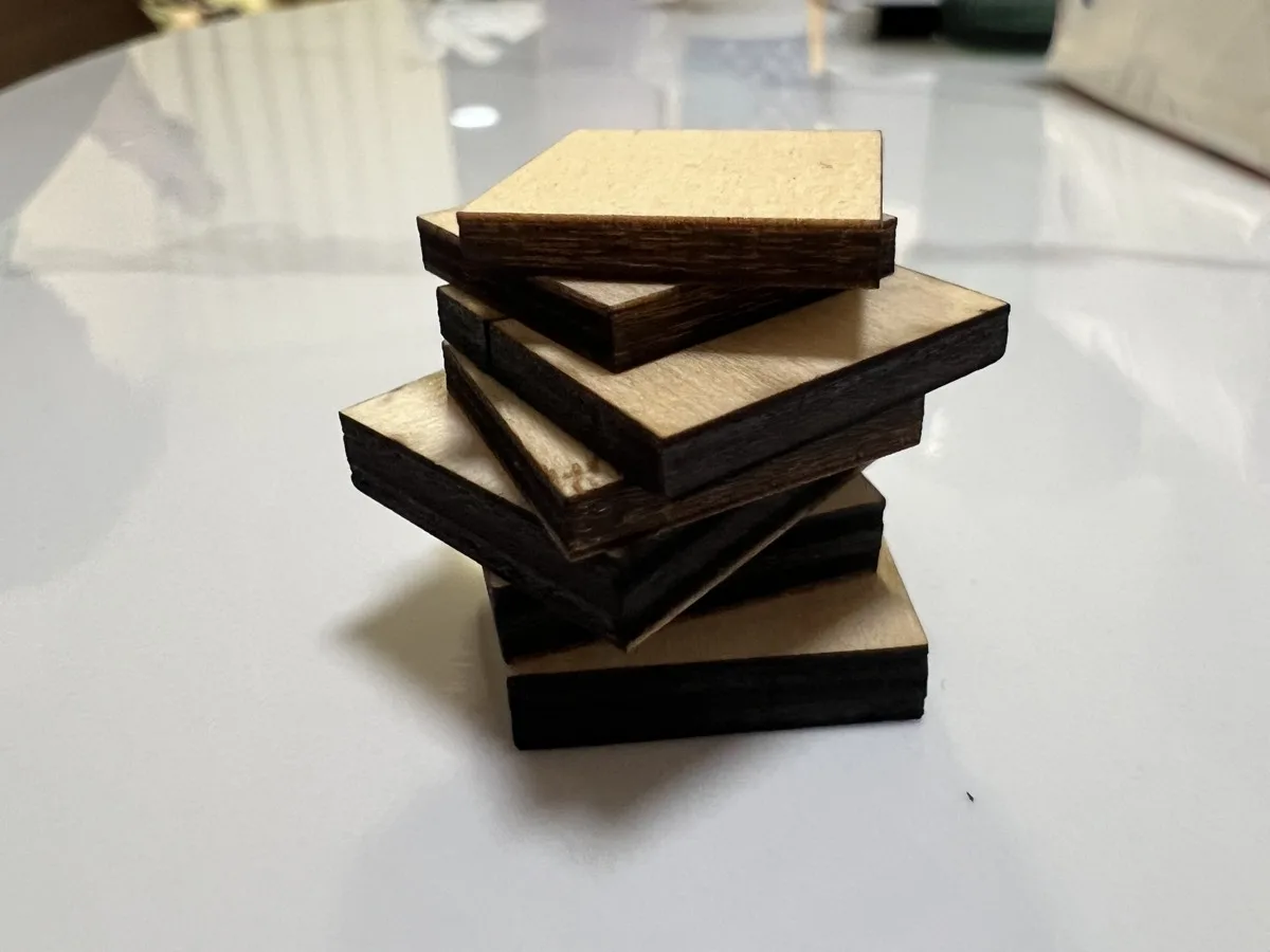 Carverall X1Pro (JL9) Review: Unboxing and Cutting Tests (2026) 18 Carverall X1Pro cut samples in basswood at 3mm, 6mm, 9mm, and 12mm thickness, stacked together after testing