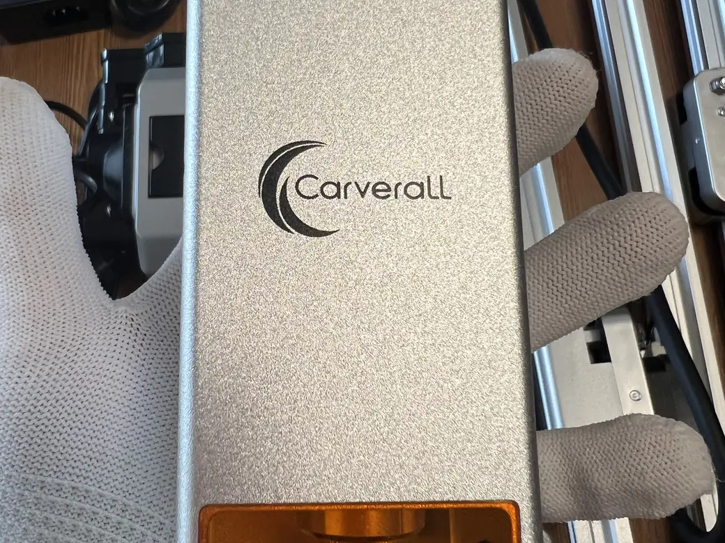 Carverall X1Pro Unboxing: Specs, Price, and What's in the Box (2026) 8 Closeup of the Carverall X1Pro laser head module in silver-champagne aluminum with the amber-tinted lens window