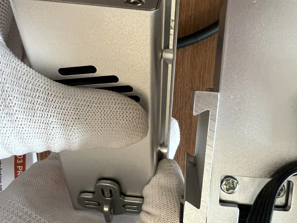 Carverall X1Pro Unboxing: Specs, Price, and What's in the Box (2026) 12 Mounting the Carverall X1Pro power module onto the frame with its two screws, showing the ventilation slots