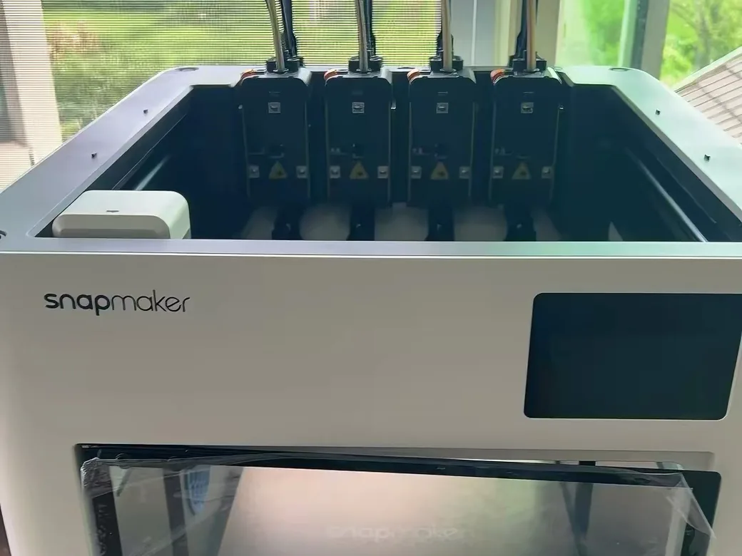 Creality K3 vs Snapmaker U1: Buy Now or Wait? (2026) 7 Snapmaker U1 on a desk with its four toolheads and feed tubes visible and the door film still attached