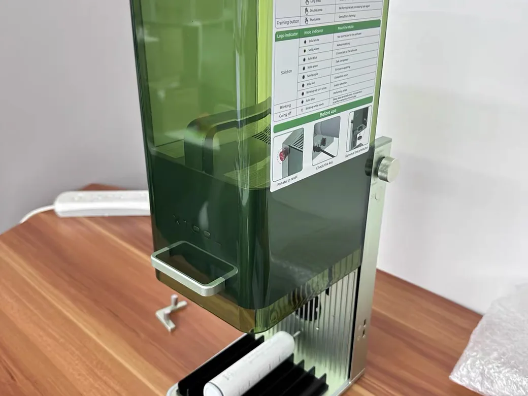 xTool F1 enclosed laser engraver on a wooden workshop desk