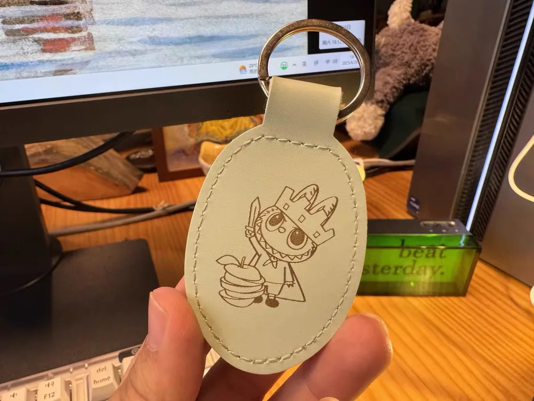 Leather keychain with a laser-engraved illustration made with an xTool F1