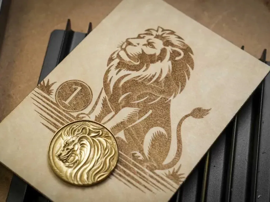 Gold relief coin and matching engraving made with the xTool F2 Ultra's 60W MOPA laser
