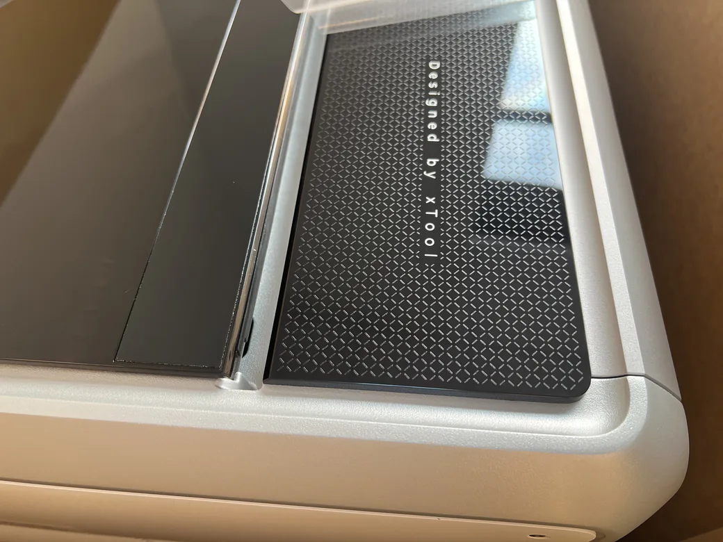 Best Laser Engraver Black Friday Deals 2026: When Sales Start and What to Pay 19 Rear glass trim on the xTool X1 with Designed by xTool lettering and a rounded silver aluminum frame